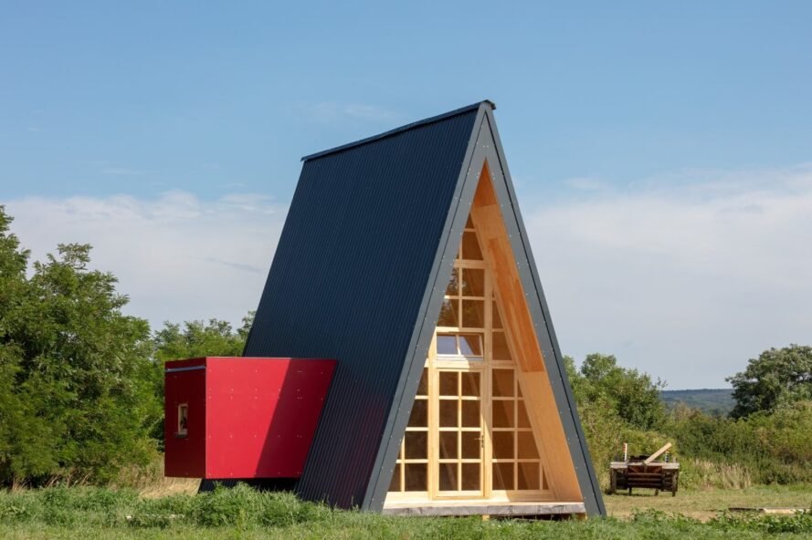dark triangular cabin with red box to one side