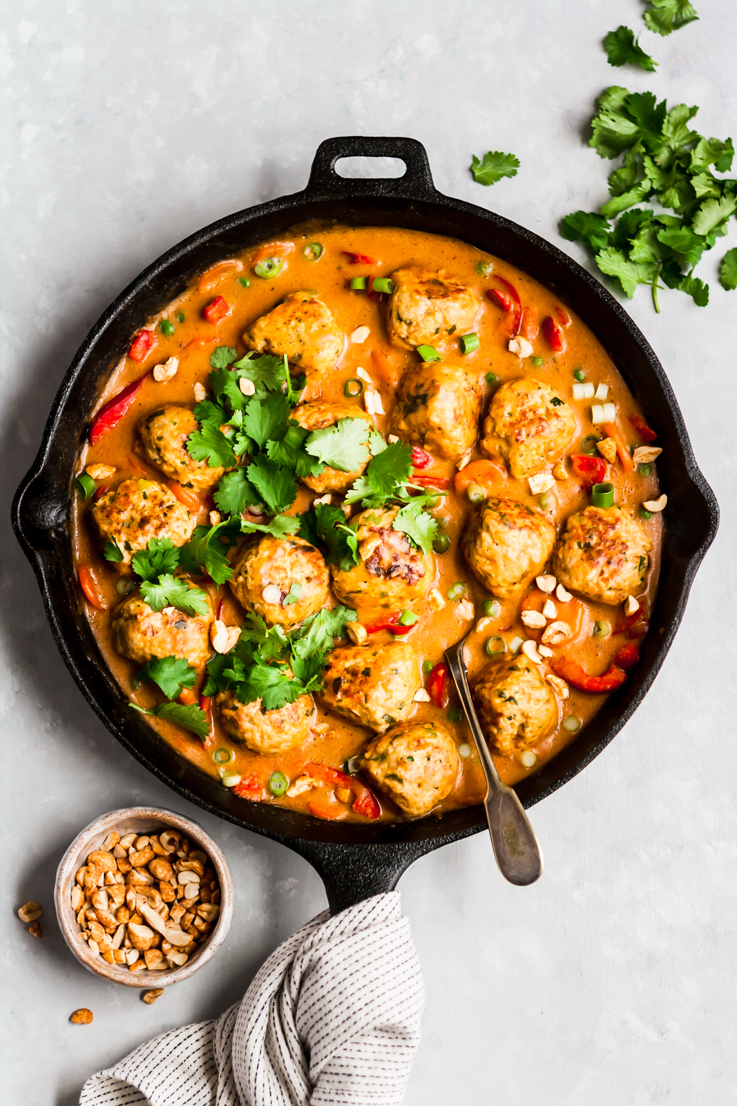 ginger chicken meatballs in peanut sauce in a skillet