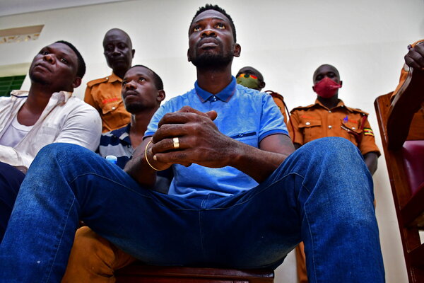 Robert Ssentamu Kyagulanyi, center, also known as Bobi Wine, appears in court in Iganga, Uganda, last week. Mr. Wine is running for president of Uganda and as an opposition candidate has faced intense intimidation.