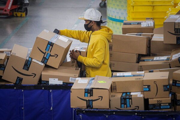 An employee scanning packages at an Amazon distribution center in Staten Island, N.Y., this week.