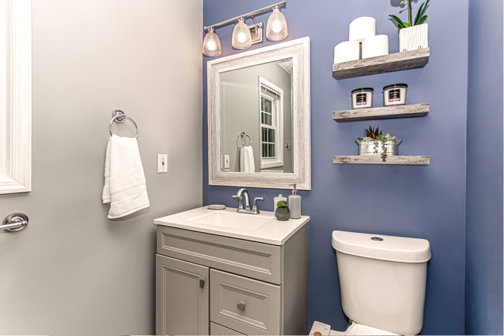 blue bathroom with vanity and toilet