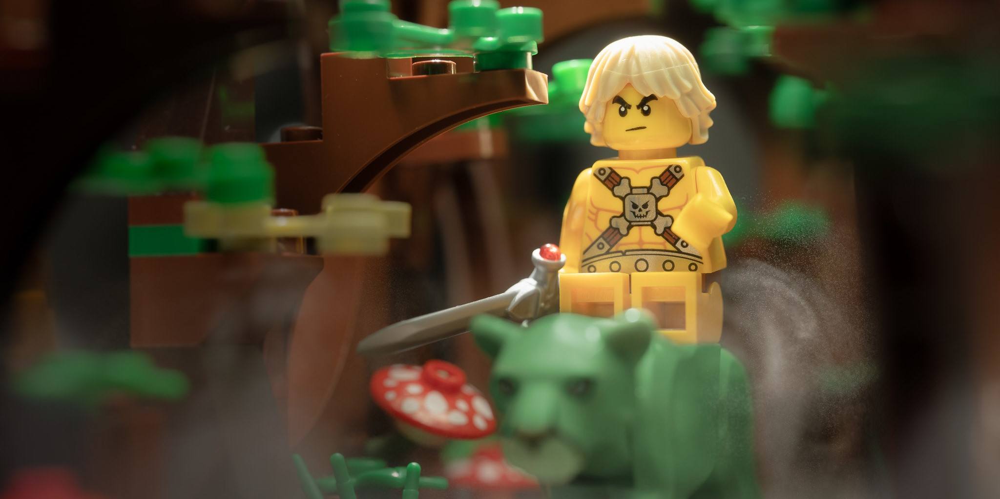 a photo of a LEGO riding a tiger, He-Man style