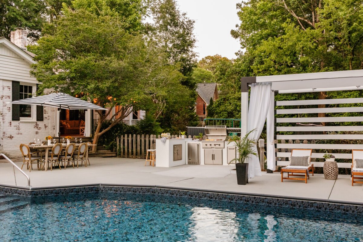 backyard with pool outdoor kitchen pergola cabana and outdoor dining table