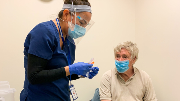 Nurse Modesta Littleman vaccinated patient Peter Sulewski in late January, on the first day of vaccinations at a clinic run by Health Care for the Homeless in Baltimore.