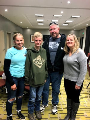 Cooper Meshew (center left) stands with some friends he has in Idaho. He met them years ago when he went hunting in Idaho but still stays in touch with them today.